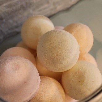 A bowl of fruit is shown with some peaches.