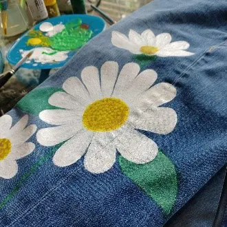 A close up of the flowers on a denim shirt