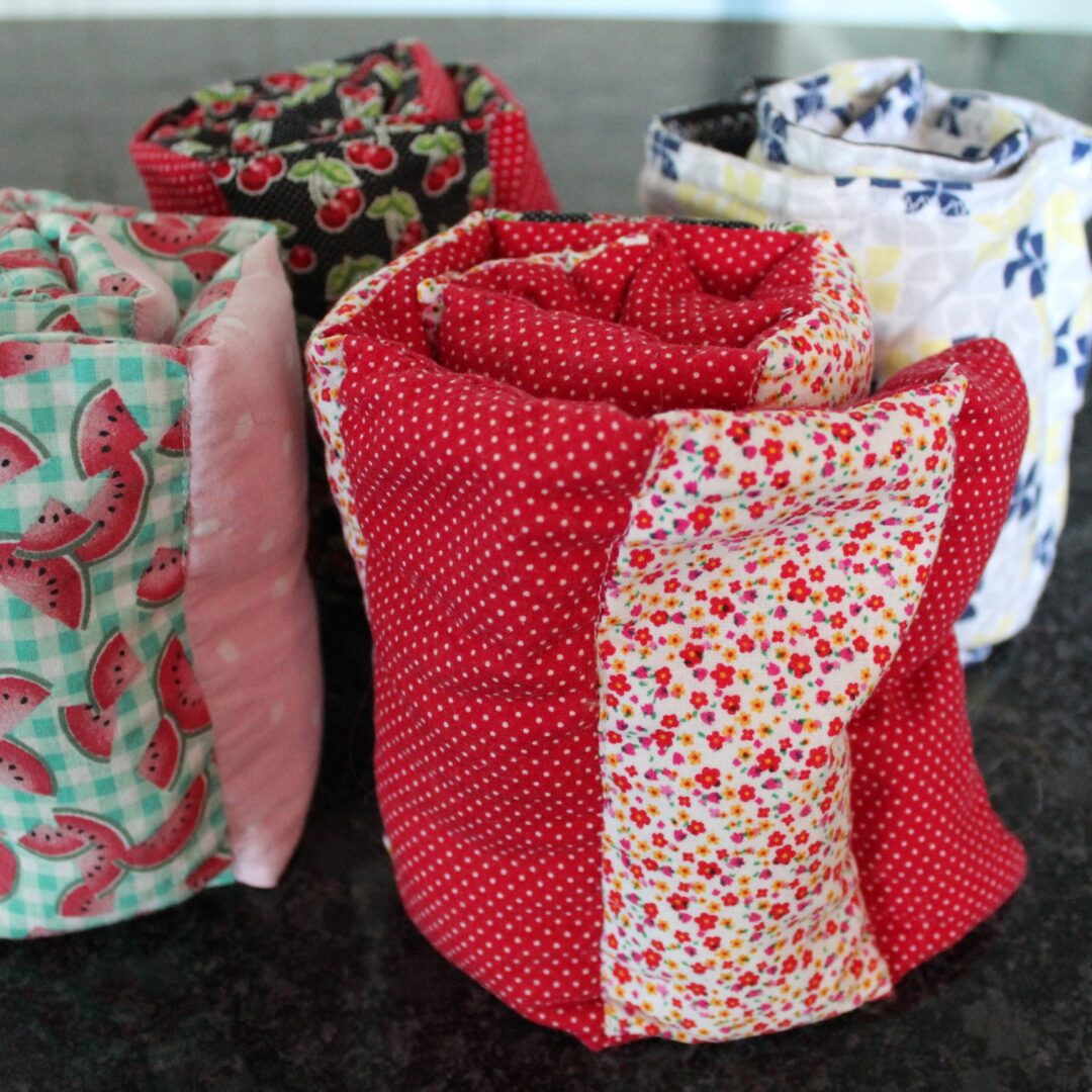 A group of rolls of fabric sitting on top of a table.