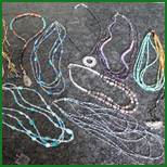 A group of necklaces on the ground.