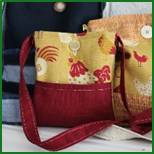 Two bags with a red strap and chicken print.