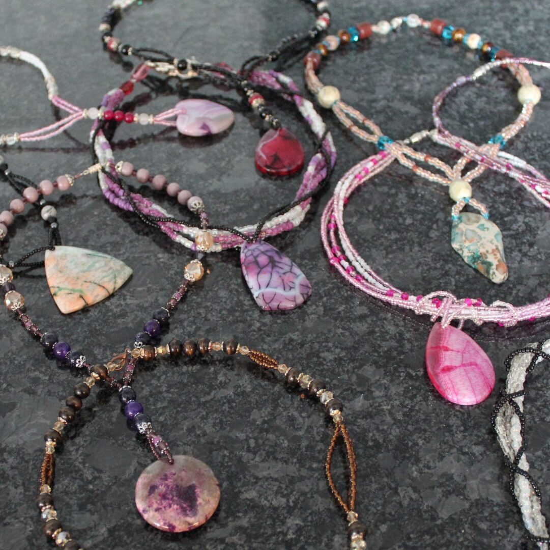 A group of necklaces that are all different colors.